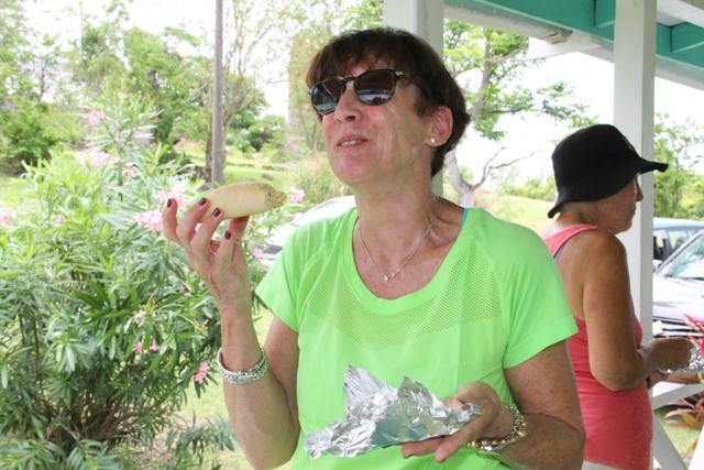 Mary Kay, from the United States of America sampling a traditional coconut tart at the Ministry of Tourism’s Open Day on May 11, 2017, at the Nevisian Heritage Village in Fothergills